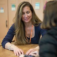 Tracy Bettencourt teaching a student in a class