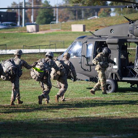 soldiers lined up to get in a helicopter